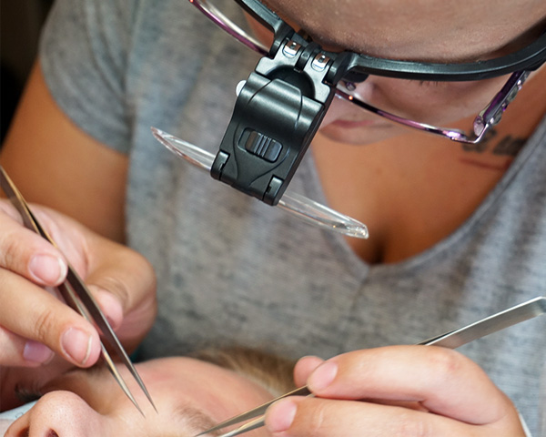 Applying eyelash extensions 